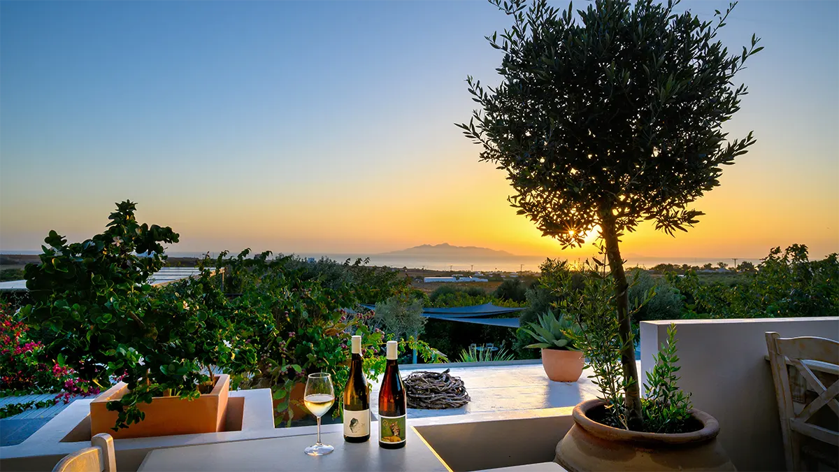 Romantic corner in Aroma Avlis with a view of the Anafi island and the sunset.